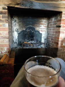 Pint by the fireplace in the Fritton Lake Clubhouse